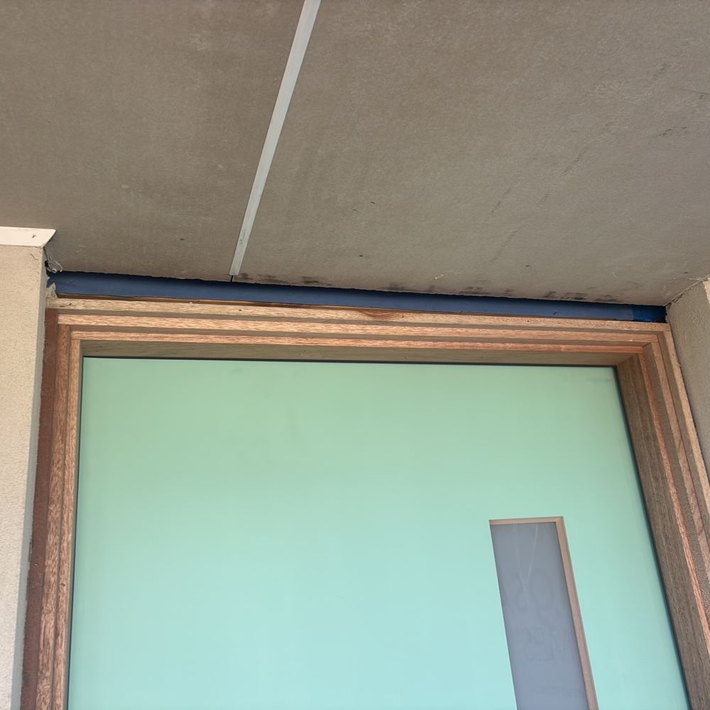 Gaps at the door head and sides over tolerance and needing infill, found during a fixing inspection in Maddingley
