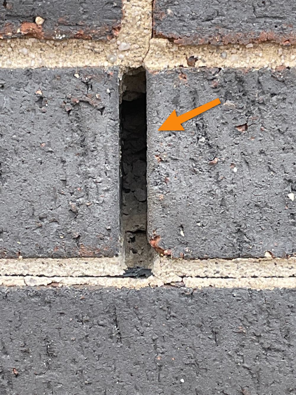 Weep holes blocked with mortar and render, trapping cavity moisture, found during a pre-handover inspection in Bacchus Marsh