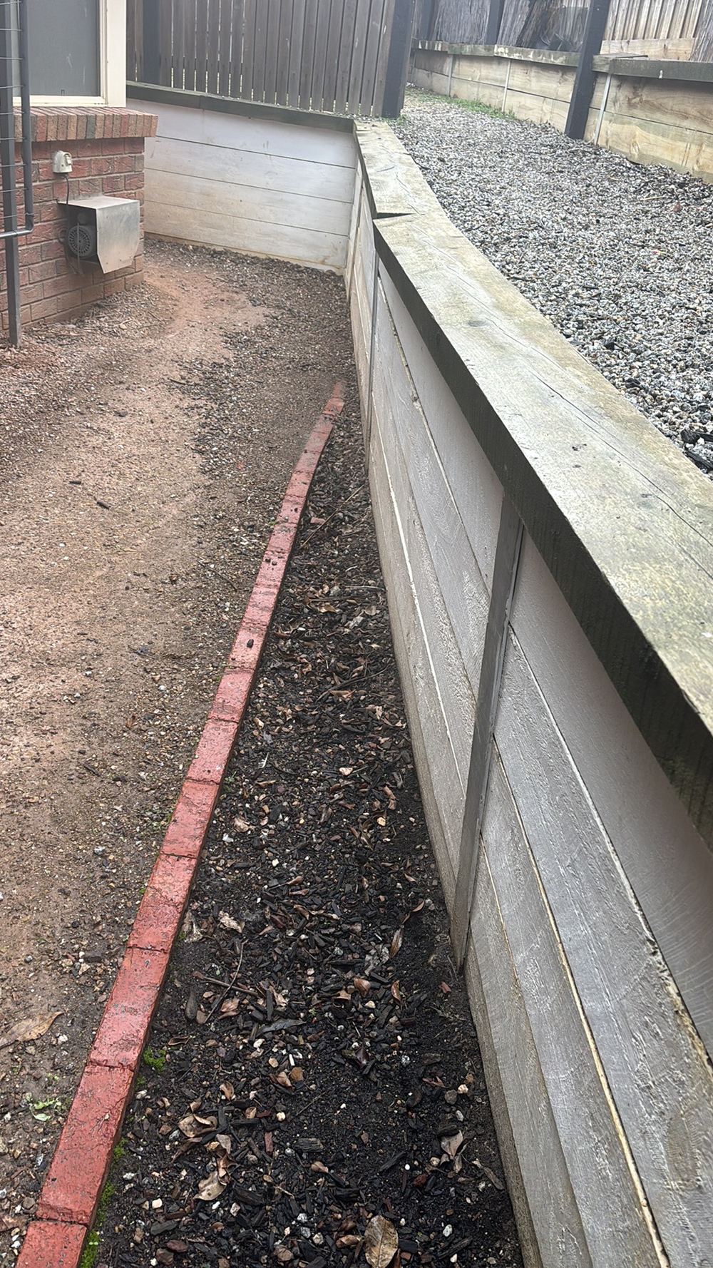 Retaining wall bowing and heaving as the ground behind it shifts, found during a pre-purchase inspection in Darley