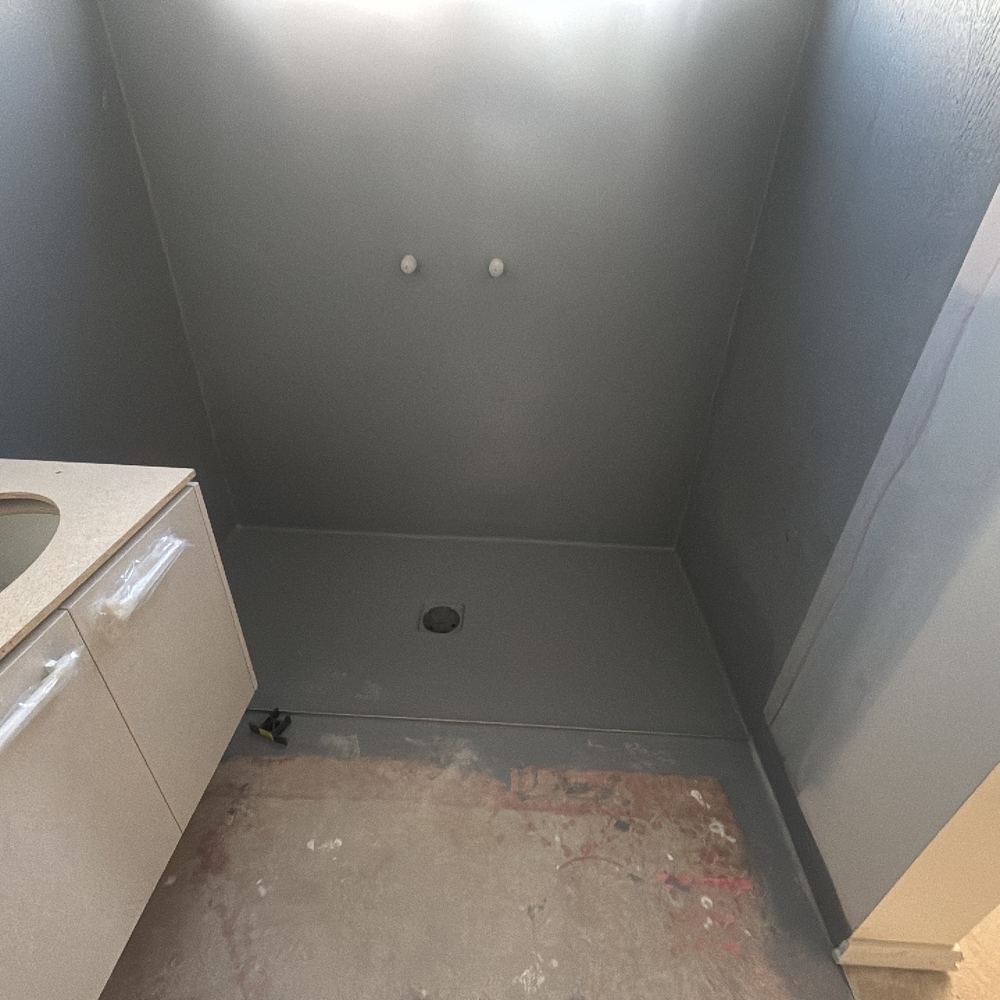 Membrane left exposed to damage before the tiler covers it, found during a waterproofing inspection in Maddingley